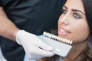 cosmetic dentist showing patient composite veneers in bentonville, ar